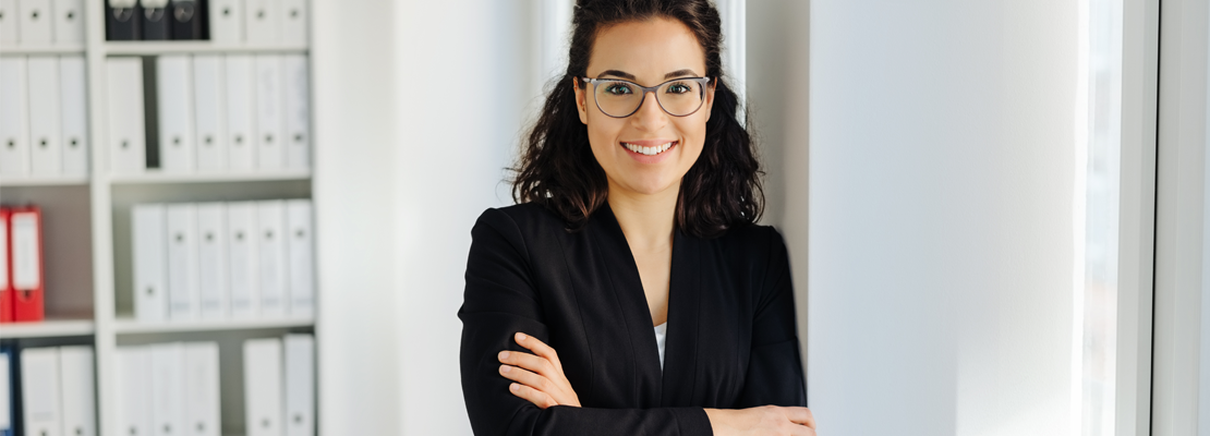 A young female engineer smiling in her office.